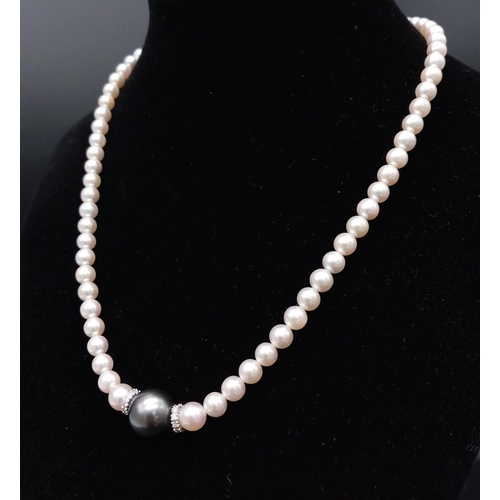 653 - A Wonderful South Sea, White Pearl Necklace with a Tahitian Black Pearl and Diamond Centrepiece. 750... 