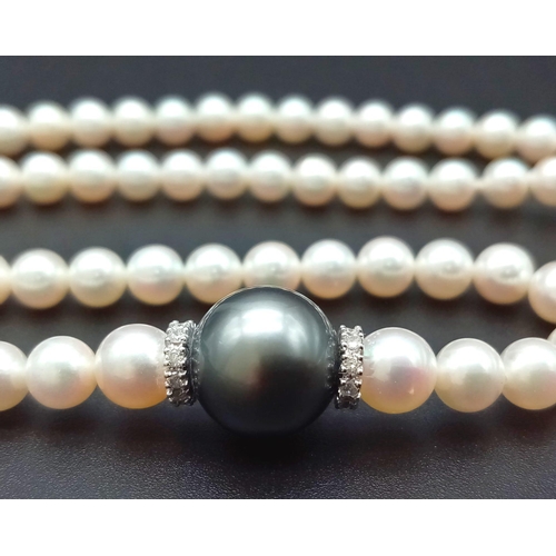 653 - A Wonderful South Sea, White Pearl Necklace with a Tahitian Black Pearl and Diamond Centrepiece. 750... 