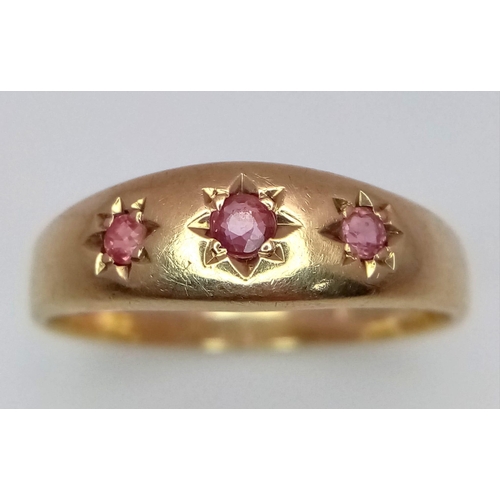 660 - A 9K Yellow Gold Three Stone Ruby Gemstone Ring. Three rubies set in a star setting. Size V. 3.82g t... 