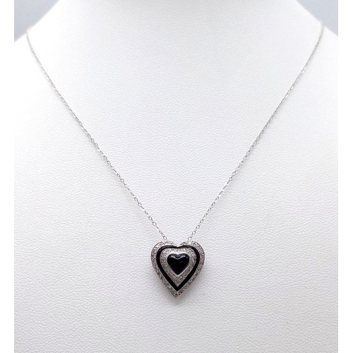 691 - An 18K White Gold Diamond and Black Onyx Heart Pendant on a 9K White Gold Disappearing Necklace. Pen... 