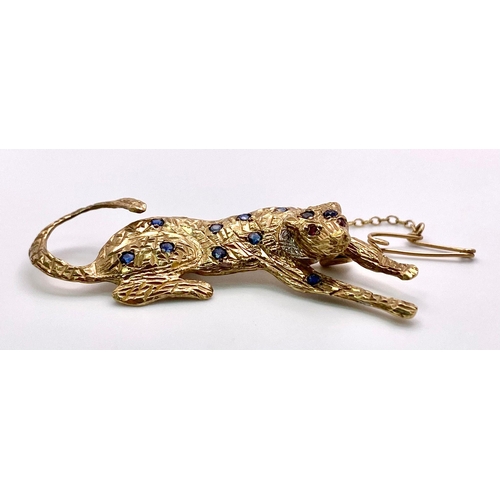 855 - A 9K Yellow Gold, Sapphire, Ruby and Diamond Decorative Panther Brooch - with safety chain. 5cm. 6.9... 