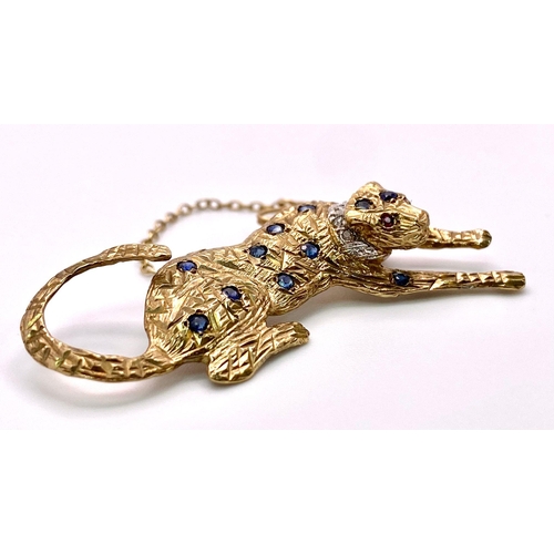 855 - A 9K Yellow Gold, Sapphire, Ruby and Diamond Decorative Panther Brooch - with safety chain. 5cm. 6.9... 