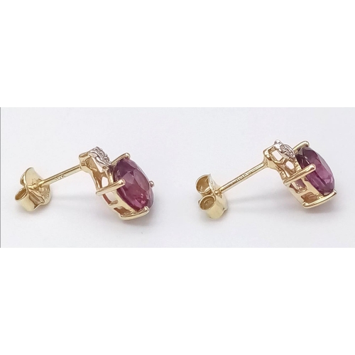 1073 - A Pair of 10K Yellow Gold Diamond and Ruby Stud Earrings. 
2g total weight.