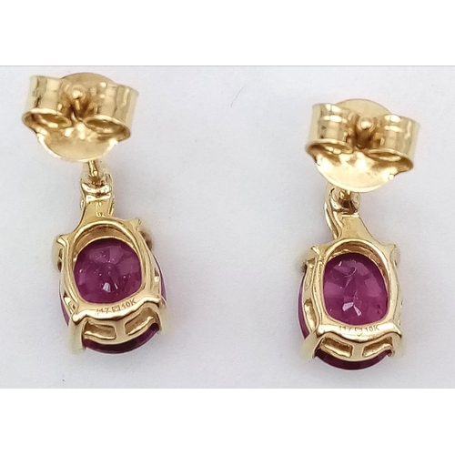 1073 - A Pair of 10K Yellow Gold Diamond and Ruby Stud Earrings. 
2g total weight.