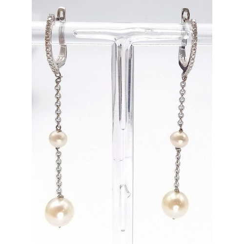 1114 - A Pair of 18k White Gold and Diamond Pearl Drop Earrings. Lever-back clasp. 5cm drop. 3.15g total we... 