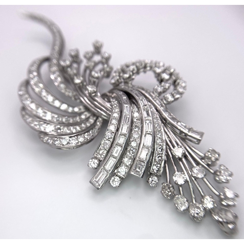 190 - An Art Deco Style Platinum and Diamond Brooch. A twisted foilage burst of 10ctw of VS clarity baguet... 