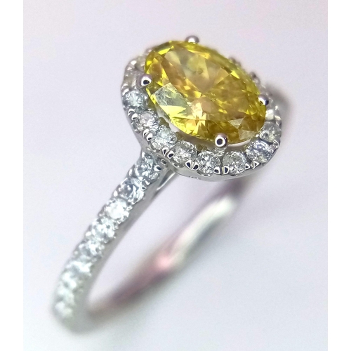 226 - A 950 Platinum Ring set with an Oval Cut Natural Fancy Vivid Yellow Central Diamond (VS2 clarity) wi... 