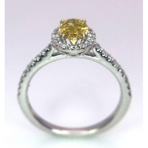 226 - A 950 Platinum Ring set with an Oval Cut Natural Fancy Vivid Yellow Central Diamond (VS2 clarity) wi... 