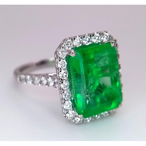 240 - A Rare Transparent Green Rectangular Cut Natural  Colombian Emerald and Diamond Ring. A 6.19ct centr... 