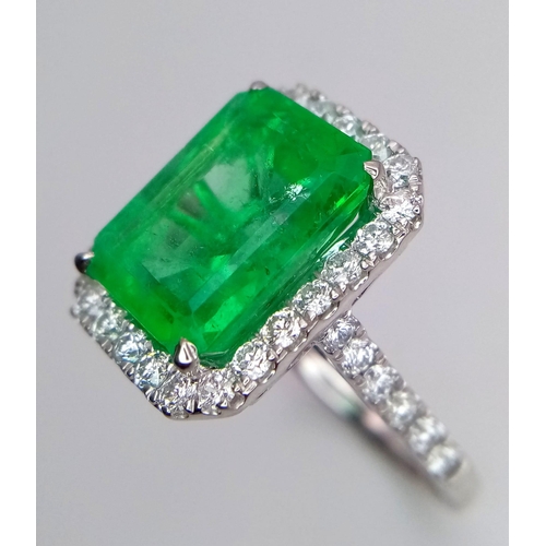 240 - A Rare Transparent Green Rectangular Cut Natural  Colombian Emerald and Diamond Ring. A 6.19ct centr... 