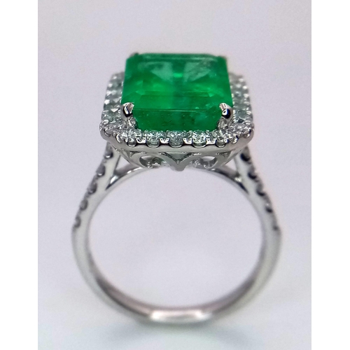 240 - A Rare Transparent Green Rectangular Cut Natural  Colombian Emerald and Diamond Ring. A 6.19ct centr... 