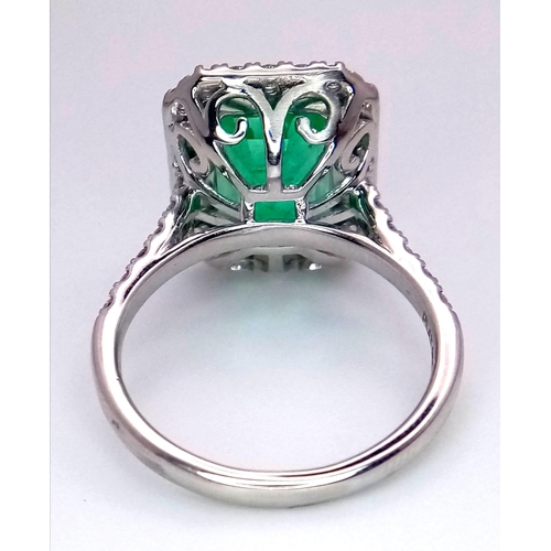 240 - A Rare Transparent Green Rectangular Cut Natural  Colombian Emerald and Diamond Ring. A 6.19ct centr... 