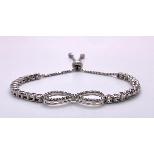 1725 - A STERLING SILVER STONE SET INFINITY ADJUSTABLE BRACELET 8.2G
ref: SC 5077