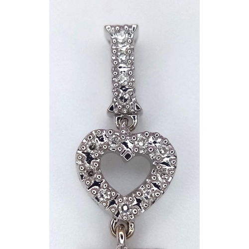 1290 - An 18K White Gold and Diamond Encrusted 'I Love You' Pendant. 4.5cm length. 3.4g total weight.