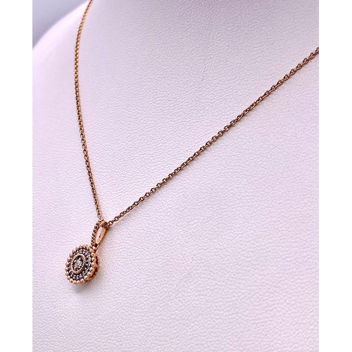 214 - A 14K ROSE GOLD DIAMOND SET PENDANT ON CHAIN. 1.5cm and 49cm, 2.6g total weight.