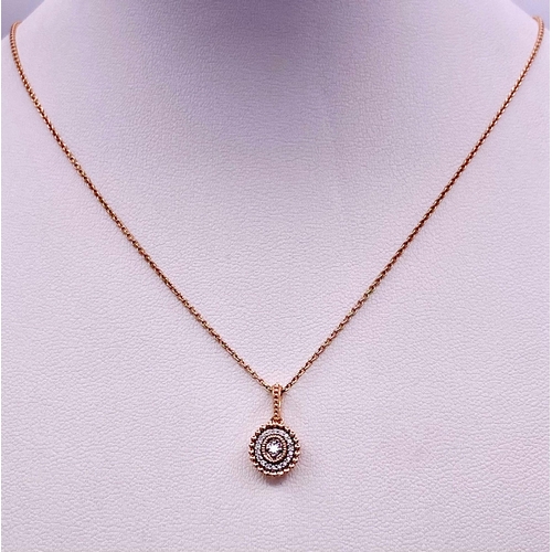 214 - A 14K ROSE GOLD DIAMOND SET PENDANT ON CHAIN. 1.5cm and 49cm, 2.6g total weight.