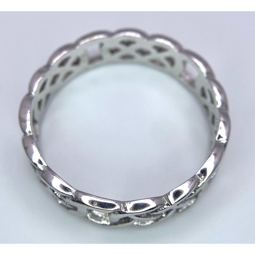 235 - A 9K WHITE GOLD CELTIC BAND RING. Size Z+1, 4.7g total weight.