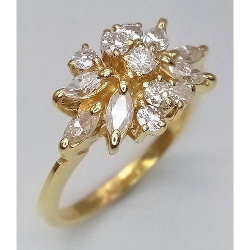 254 - An 18K Yellow Gold and Diamond Decorative Floral Ring. Central brilliant round cut diamond with marq... 