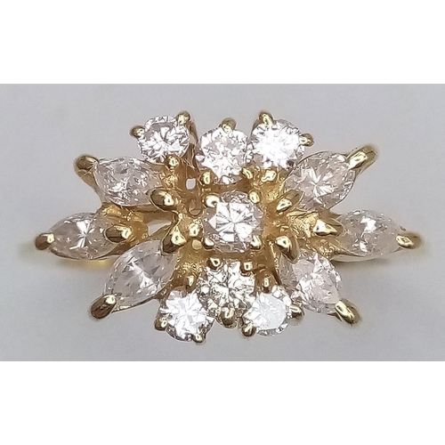 254 - An 18K Yellow Gold and Diamond Decorative Floral Ring. Central brilliant round cut diamond with marq... 