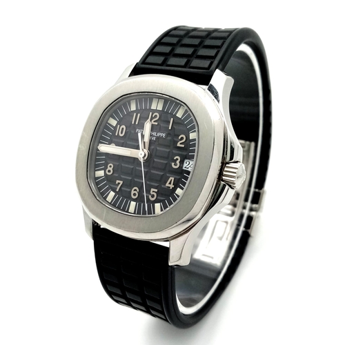 29 - A Patek Phillippe Aquanaut Watch. Textured black rubber strap. Stainless steel case - 36mm. Black te... 