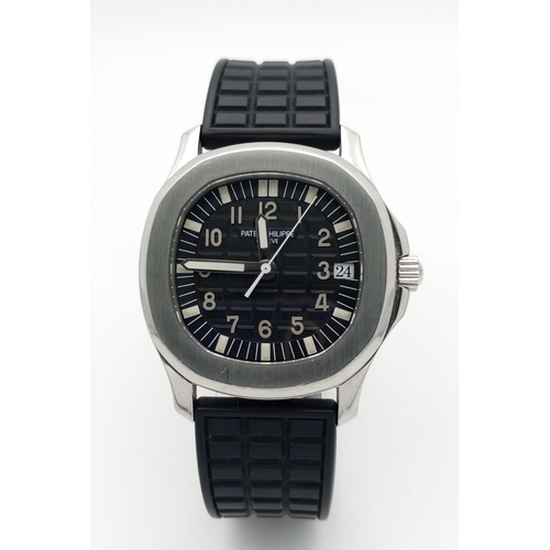 29 - A Patek Phillippe Aquanaut Watch. Textured black rubber strap. Stainless steel case - 36mm. Black te... 