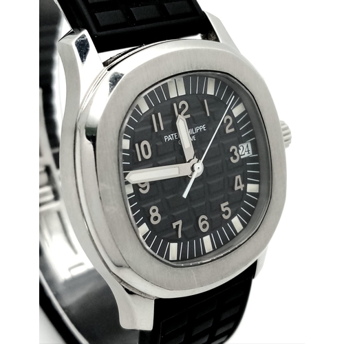 29 - A Patek Phillippe Aquanaut Watch. Textured black rubber strap. Stainless steel case - 36mm. Black te... 