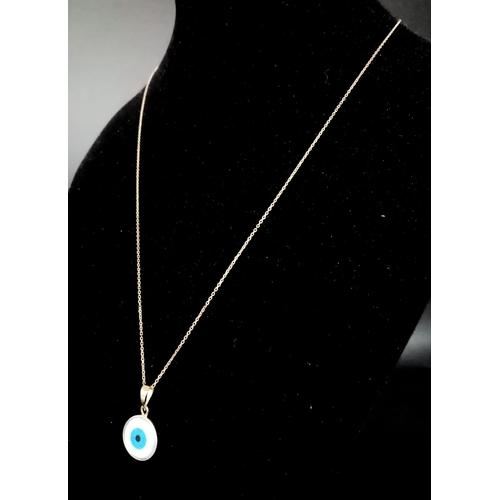 317 - An 18K Gold and Enamel Evil Eye Pendant on an 18K Yellow Gold Disappearing Necklace. 12mm diameter p... 