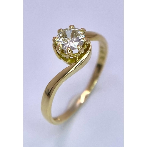 74 - An 18K Yellow Gold Diamond Crossover Ring. Brilliant round cut diamond, slight tint - 0.40ct. Size L... 