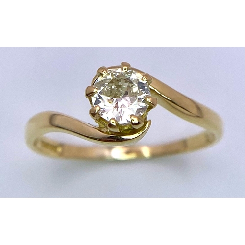 74 - An 18K Yellow Gold Diamond Crossover Ring. Brilliant round cut diamond, slight tint - 0.40ct. Size L... 