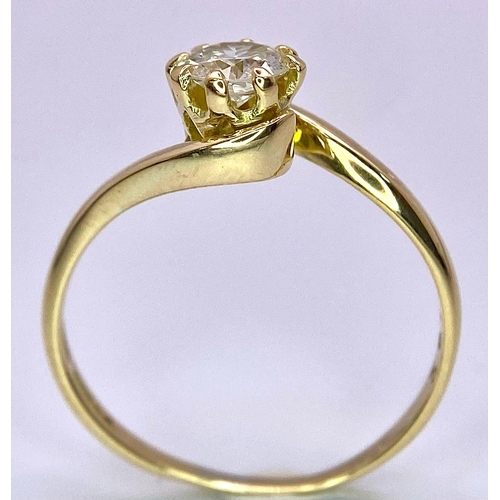 74 - An 18K Yellow Gold Diamond Crossover Ring. Brilliant round cut diamond, slight tint - 0.40ct. Size L... 