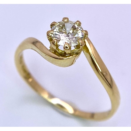 74 - An 18K Yellow Gold Diamond Crossover Ring. Brilliant round cut diamond, slight tint - 0.40ct. Size L... 