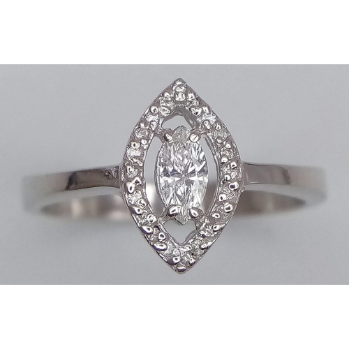 87 - An 18K White Gold and Marquise Cut Diamond Ring. Central bright marquise cut diamond with a round cu... 