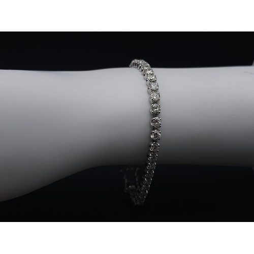 324 - A 5ct Diamond 900 Platinum Tennis Bracelet. 38 brilliant round cut diamonds of a high grade create a... 