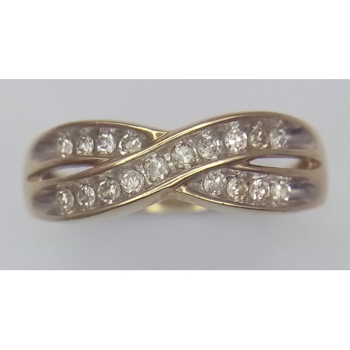 599 - 9K YELLOW GOLD, DIAMOND 2 ROW CROSSOVER RING.
0.25CTW, WEIGHS 2.6G AND SIZE O.

REF: SC 7085