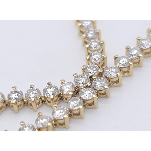 673 - An 18K Yellow Gold and 5ct Diamond Tennis Bracelet. 56 high-grade brilliant round cut diamonds give ... 