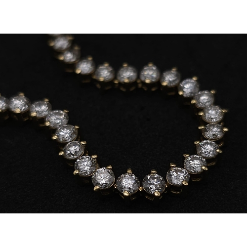 673 - An 18K Yellow Gold and 5ct Diamond Tennis Bracelet. 56 high-grade brilliant round cut diamonds give ... 