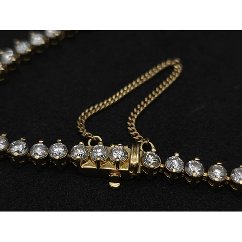 673 - An 18K Yellow Gold and 5ct Diamond Tennis Bracelet. 56 high-grade brilliant round cut diamonds give ... 