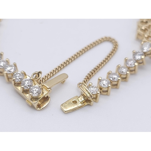 673 - An 18K Yellow Gold and 5ct Diamond Tennis Bracelet. 56 high-grade brilliant round cut diamonds give ... 