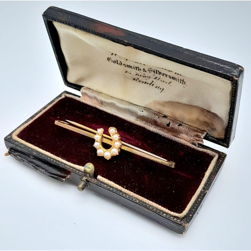 218 - AN ANTIQUE 9K GOLD BAR BROOCH WITH LUCKY HORSESHOE DECORATED WITH SEED PEARLS, IN ORIGINAL BOX .    ... 