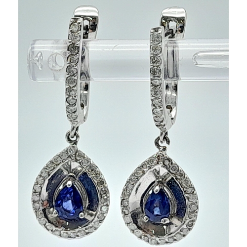 303 - A Pair of 18K White Gold Diamond and Sapphire Teardrop Earrings. Teardrop sapphires with teardrop di... 