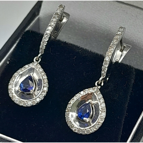 303 - A Pair of 18K White Gold Diamond and Sapphire Teardrop Earrings. Teardrop sapphires with teardrop di... 