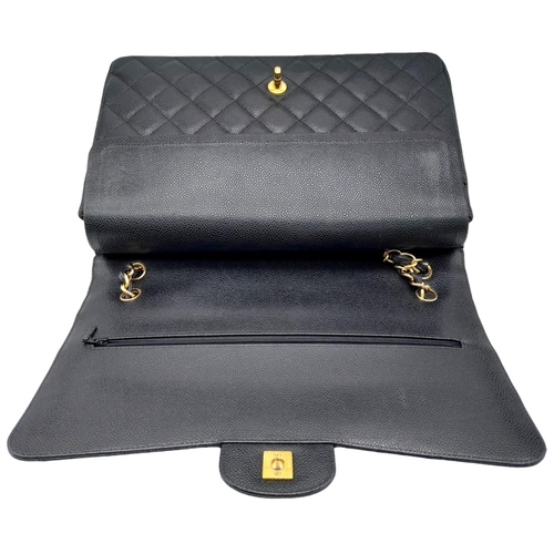 598 - Black Chanel Maxi Bag.
Quilted leather stitched in diamond pattern. Gold toned hardware and typical ... 