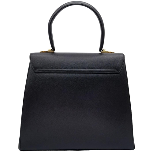 199 - A Salvatore Ferragamo Black Iconic Top Handle Bag. Leather exterior with gold toned hardware, 4 prot... 