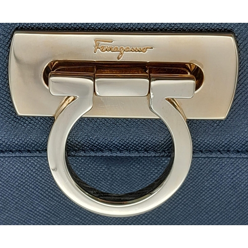 199 - A Salvatore Ferragamo Black Iconic Top Handle Bag. Leather exterior with gold toned hardware, 4 prot... 