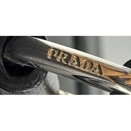 213 - A Prada Black Briefcase. Saffiano leather exterior with two rolled handles, silver toned hardware, P... 