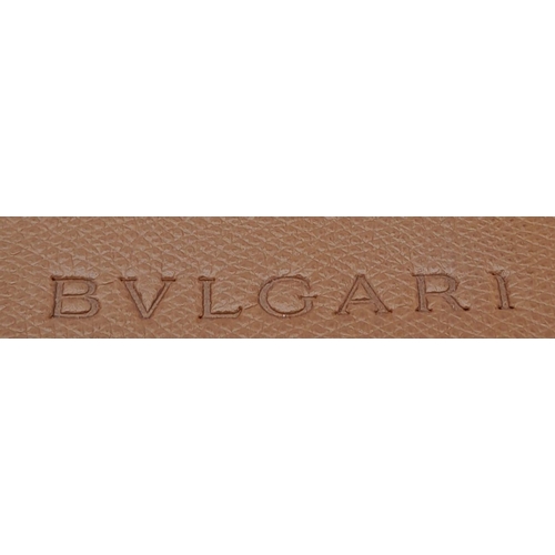 256 - A Bvlgari Tan Bag. Leather exterior with gold toned hardware, leather strap, flap and twist-clasp cl... 