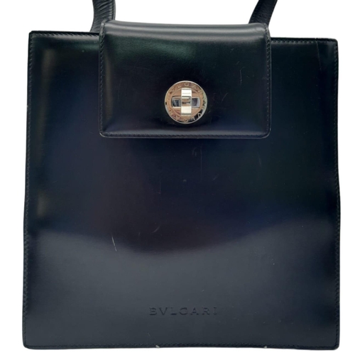 291 - A Bvlgari Black Bag. Leather exterior with silver toned hardware, leather strap, flap and twist-clas... 