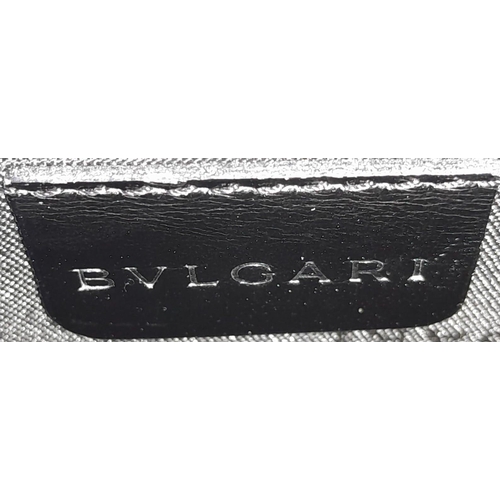 291 - A Bvlgari Black Bag. Leather exterior with silver toned hardware, leather strap, flap and twist-clas... 