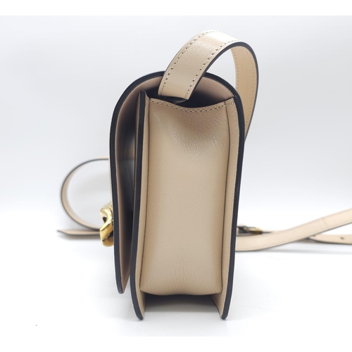 32 - A Givenchy Nude Infinity Crossbody Bag. Leather exterior with front flap, gold toned hardware, adjus... 