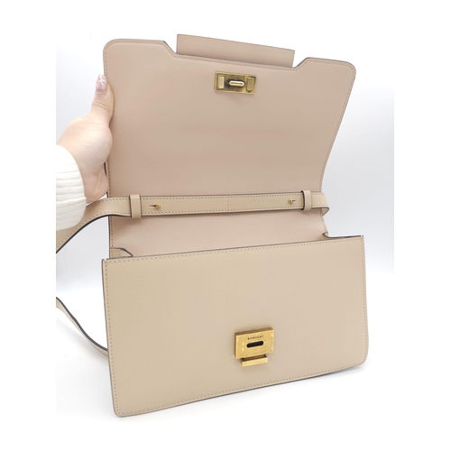 32 - A Givenchy Nude Infinity Crossbody Bag. Leather exterior with front flap, gold toned hardware, adjus... 